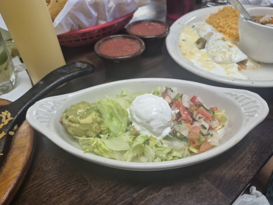 Printed menu with tacos, fajitas, and enchiladas.