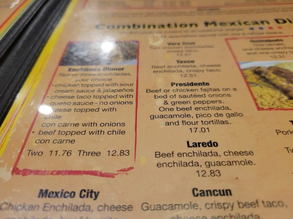Printed menu with tacos, fajitas, and enchiladas.